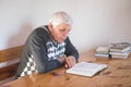 Senior man praying, reading an old Bible. Hands folded in prayer on a Holy Bible in church concept for faith, spirituality and Royalty Free Stock Photo