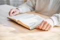 Senior man praying, reading  an old Bible in his hands Royalty Free Stock Photo