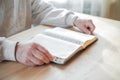 Senior man praying, reading  an old Bible in his hands Royalty Free Stock Photo