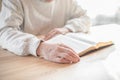 Senior man praying, reading  an old Bible in his hands Royalty Free Stock Photo