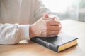 Senior man praying, reading  an old Bible in his hands Royalty Free Stock Photo