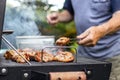 Senior man preparing barbecue grill for garden party Royalty Free Stock Photo