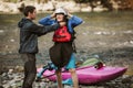 Senior man preparing for kayak tour on a mountain river