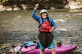 Senior man preparing for kayak tour on a mountain river