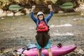 Senior man preparing for kayak tour on a mountain river