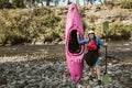 Senior man preparing for kayak tour on a mountain river