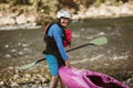 Senior man preparing for kayak tour on a mountain river