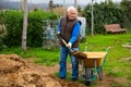 Senior man preparing manure for fertilizing land