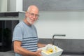Senior man preparing meal in the kitchen Royalty Free Stock Photo