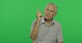 Senior man quarrels at someone. Handsome old man on chroma key background