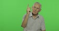 Senior man quarrels at someone. Handsome old man on chroma key background