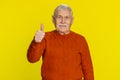 Senior man raises thumbs up agrees or gives positive reply recommends advertisement likes good idea