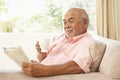 Senior Man Reading Book With Drink At Home Royalty Free Stock Photo