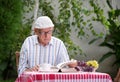 Senior man reading book in garden Royalty Free Stock Photo