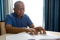 Senior man reading braille book in retirement home Royalty Free Stock Photo