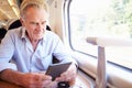 Senior Man Reading E Book On Train Journey Royalty Free Stock Photo