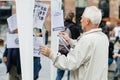 Senior man reading manifest against Macron