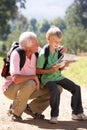 Senior man reading map with grandson Royalty Free Stock Photo