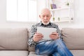 Senior man reading news on digital tablet Royalty Free Stock Photo