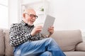 Senior man reading news on digital tablet Royalty Free Stock Photo