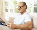 Senior Man Reading Newspaper At Home Royalty Free Stock Photo