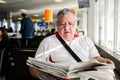 Senior man reading newspaper