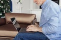 Senior man using modern laptop in home office Royalty Free Stock Photo