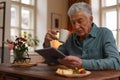 Senior man reading something in digital tablet. Royalty Free Stock Photo