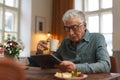 Senior man reading something in digital tablet. Royalty Free Stock Photo