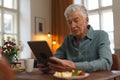 Senior man reading something in digital tablet. Royalty Free Stock Photo