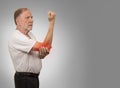 Senior man with red elbow inflammation suffering from pain