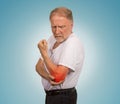 Senior man with red elbow inflammation suffering from pain