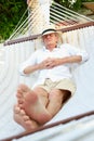 Senior Man Relaxing In Beach Hammock Royalty Free Stock Photo