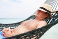 Senior Man Relaxing In Beach Hammock Royalty Free Stock Photo