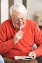 Senior Man Relaxing In Chair Royalty Free Stock Photo