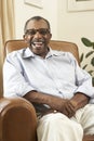 Senior Man Relaxing In Chair At Home Royalty Free Stock Photo