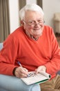 Senior Man Relaxing In Chair At Home Royalty Free Stock Photo