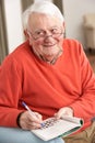 Senior Man Relaxing In Chair At Home Royalty Free Stock Photo