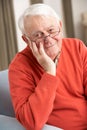 Senior Man Relaxing In Chair At Home Royalty Free Stock Photo