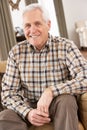 Senior Man Relaxing In Chair At Home Royalty Free Stock Photo