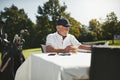 Senior man relaxing at a course restaurant after playing golf Royalty Free Stock Photo