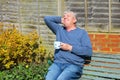 Senior man relaxing drinking coffee in garden. Royalty Free Stock Photo