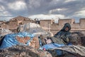 Senior man relaxing on fishing nets in front of stone wall at port