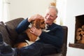 Senior Man Relaxing At Home With Pet Dog Royalty Free Stock Photo