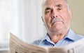 Senior man relaxing reading a newspaper Royalty Free Stock Photo