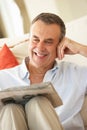 Senior Man Relaxing On Sofa Royalty Free Stock Photo