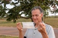 Senior Man removing his face mask Royalty Free Stock Photo