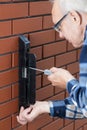 Senior man repairing gate lock