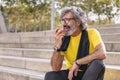 senior man rests eating an apple after workout Royalty Free Stock Photo