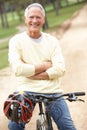 Senior man riding bicycle in park Royalty Free Stock Photo